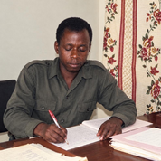 An earlier photograph of Kwabena Konadu Amankwah writing at his desk